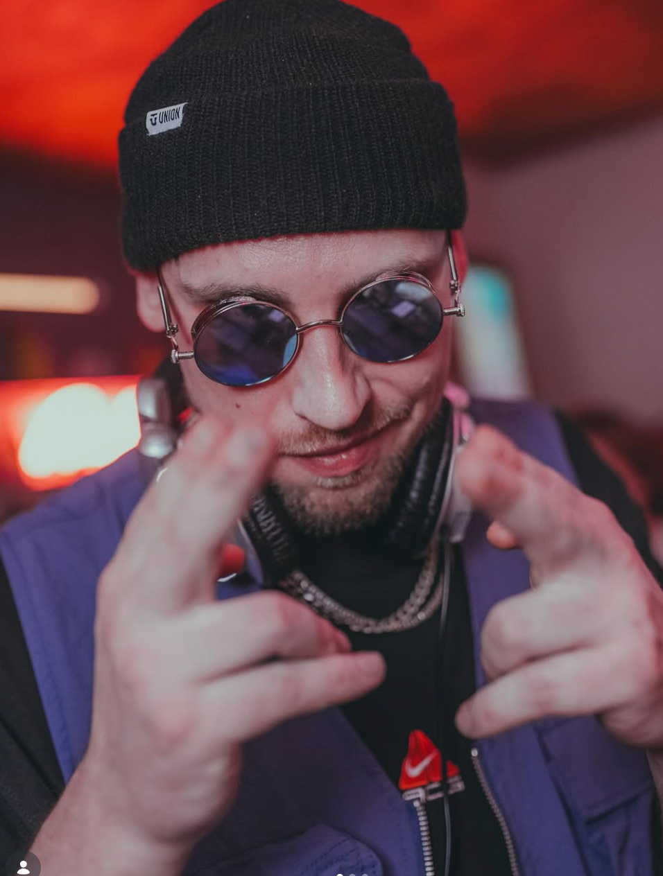 CROW wearing a beanie, glasses and headphones